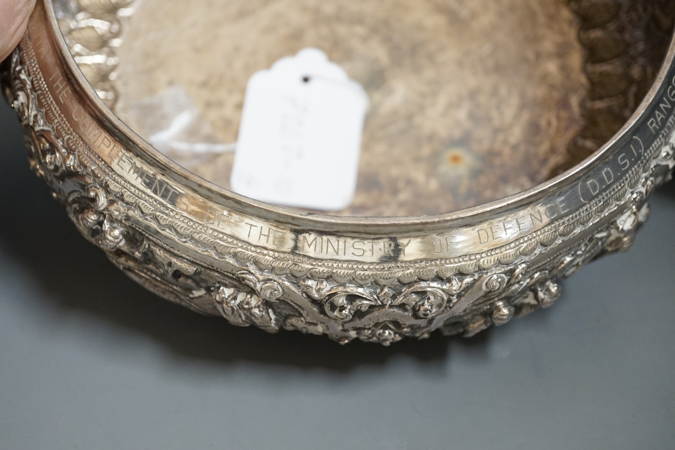 An Indian repousse white metal presentation bowl, with engraved inscription, diameter 21.5cm and a similar smaller bowl